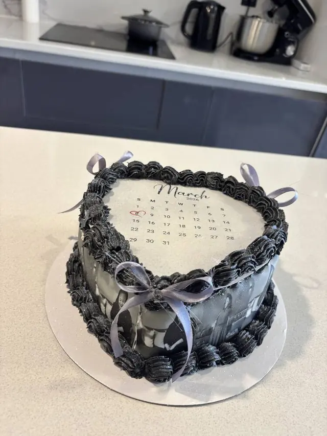 Black heart cake with March calendar and photo tier