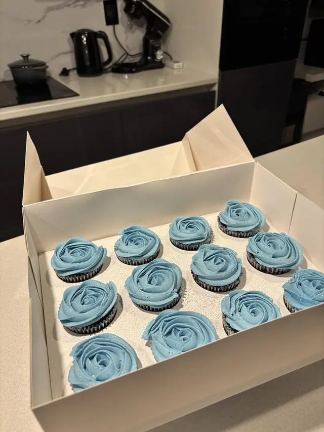 Blue glitter rosette cupcakes in a box